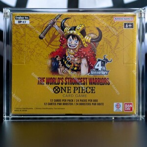 May include: A sealed One Piece Card Game booster box, The World's Strongest Warriors OP-17, encased in a clear acrylic display. The yellow box features an illustration of a character with a horned helmet, the 4th Anniversary logo, and Bandai branding.