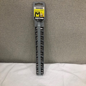May include: A Craftsman socket set in a gray plastic holder. The packaging includes a yellow label with black text and the Craftsman logo. The set is displayed against a gray textured background and a white cloth.
