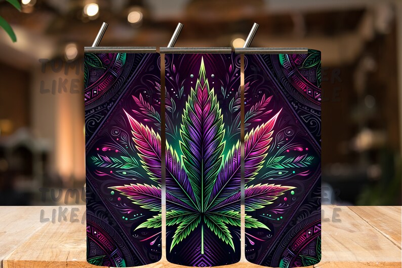 May include: Three stainless steel tumblers with a colorful psychedelic cannabis leaf design. The design features a dark purple, green, and pink leaf with intricate details.