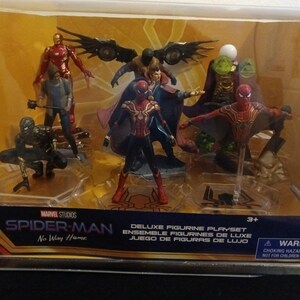 May include: A deluxe figurine playset featuring characters from the Marvel Studios movie Spider-Man: No Way Home. The set includes Spider-Man, Doctor Strange, Iron Man, and other characters. The figures are made of plastic and are approximately 3 inches tall.