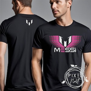 May include: Black t-shirt with a pink and white graphic of the letter "M" with the word "MESSI" underneath.