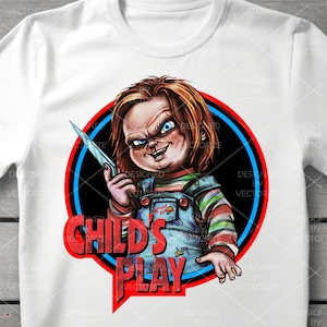 May include: A white t-shirt with a red and blue circle graphic featuring a cartoon character holding a knife. The text "Child's Play" is written in red letters inside the circle.