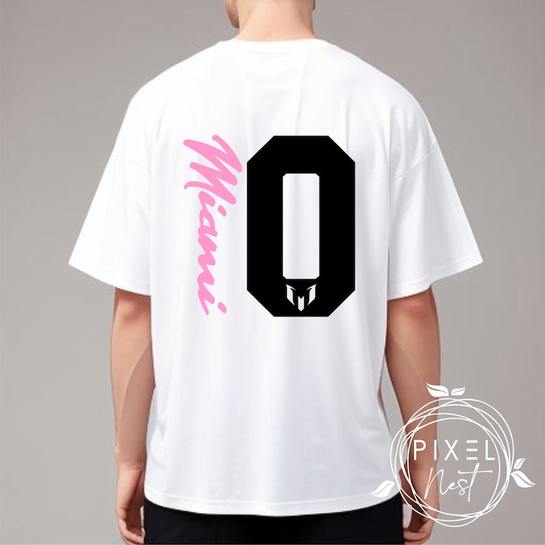 May include: White t-shirt with a black number "0" and the word "Miami" in pink script on the back.