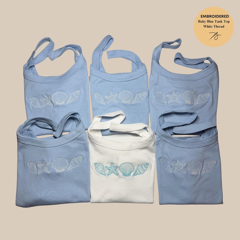May include: Baby blue tank tops with white embroidered seashell designs. One white tank top with turquoise seashell embroidery is also present. The tops have a unique strap design. The image includes text that reads "EMBROIDERED Baby Blue Tank Top White Thread".