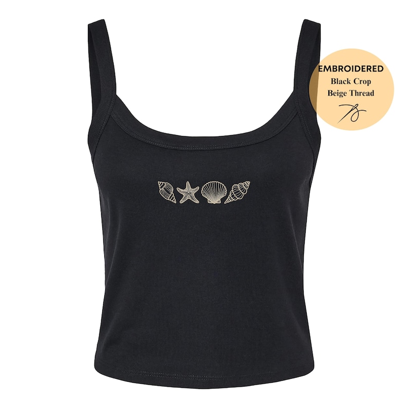 May include: Black crop top with beige thread embroidery of seashells and a starfish. The top has a scoop neckline and wide straps. The text on the image says "EMBROIDERED Black Crop Beige Thread".