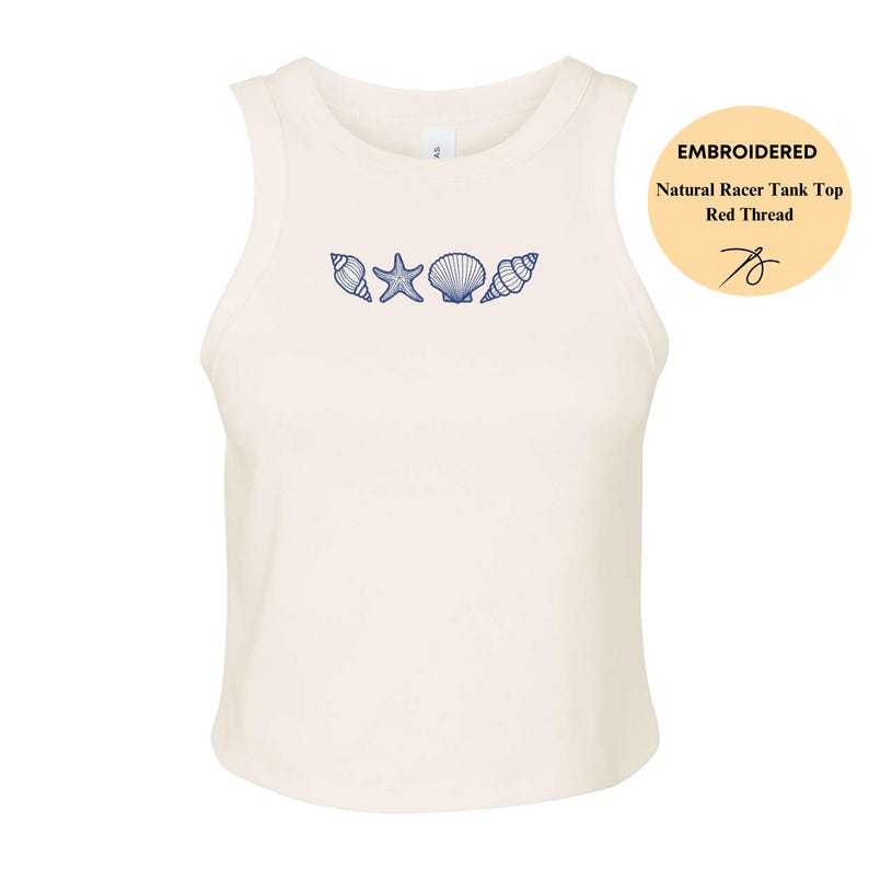 May include: Cream-colored racerback tank top with embroidered blue seashells and a starfish design. The tank top has a round neckline and is sleeveless. The text on the image says "Embroidered Natural Racer Tank Top Red Thread".