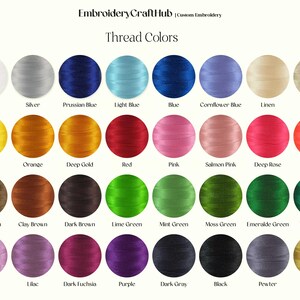 May include: A chart of 24 embroidery thread colors, arranged in four rows of six colors each. The colors are labeled with their names, including white, silver, Prussian blue, light blue, blue, cornflower blue, linen, beige, yellow, orange, deep gold, red, pink, salmon pink, deep rose, vermilion, light brown, clay brown, dark brown, lime green, mint green, moss green, emerald green, teal green, light lilac, lilac, dark fuchsia, purple, dark gray, black, pewter, and brass.