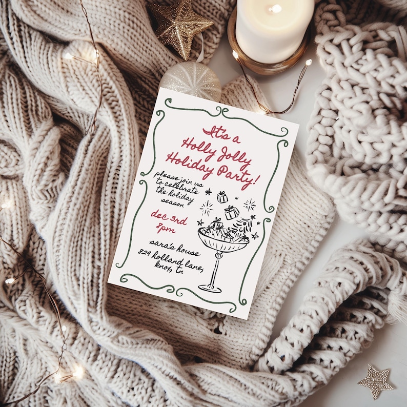 May include: A holiday party invitation with the text "It's a Holly Jolly Holiday Party!" in red and green. The invitation is on a white background, with a decorative border and a drawing of a champagne glass with gifts. The invitation is surrounded by a cozy, knitted blanket, fairy lights, and holiday ornaments.