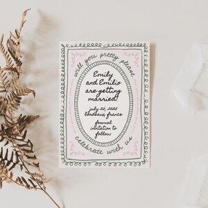 May include: A wedding announcement card with a pink and green border. The text reads "Will you pretty please... Emily and Emilio are getting married! July 25, 2025 Bondbaus, France Formal invitation to follow Celebrate with us"