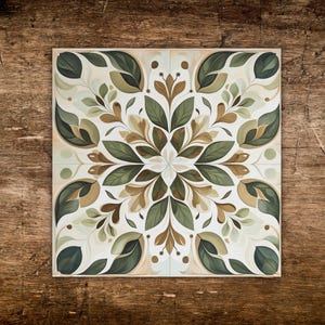 May include: Square decorative tile with a symmetrical floral design. The pattern features stylized leaves in shades of green, brown, and beige against a white background. The tile is likely made of ceramic or porcelain and is suitable for interior design projects.
