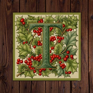 May include: A square print featuring the letter "T" in a green, ornate font, surrounded by green holly leaves and bright red berries. The design has a vintage, botanical feel, set against a cream background with a green border. The overall theme is festive.