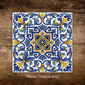 May include: Square ceramic tile with a detailed floral design in blue, yellow, and white. The tile features a central star-like pattern and ornate scrollwork. The text "Fisher Creative Arts" is at the bottom.