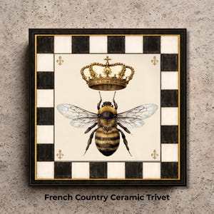 May include: Square ceramic trivet with a black and white checkered border. The trivet features a detailed illustration of a bee wearing a golden crown. The text "French Country Ceramic Trivet" is printed at the bottom.