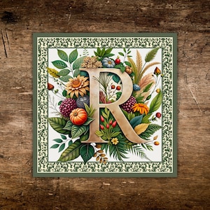 May include: Square floral art print featuring a large letter "R" in a warm beige tone, surrounded by colorful flowers, berries, and foliage. The design includes pumpkins, sunflowers, and a decorative border in shades of green and cream, set against a wooden background.
