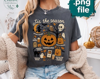 May include: Dark grey t-shirt with a Halloween graphic. The design features a jack-o'-lantern, a skull, a witch, and the text "tis the season." Other elements include ghosts, bats, and the words "spooky witches" and "trick or treating."