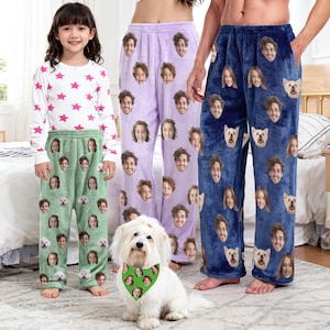 May include: Three pairs of personalized pajama pants in green, lavender, and blue, each covered with repeating faces. A child wears a white long-sleeved shirt with pink stars. A white dog with a green bandana featuring faces sits in front.