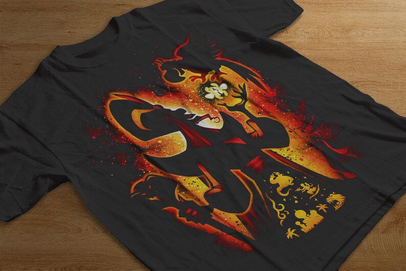 Puede incluir: Camiseta negra con un llamativo dise&ntilde;o gr&aacute;fico en tonos naranja, rojo y amarillo. El dise&ntilde;o presenta una silueta estilizada de un personaje, un elemento floral y otras formas decorativas.