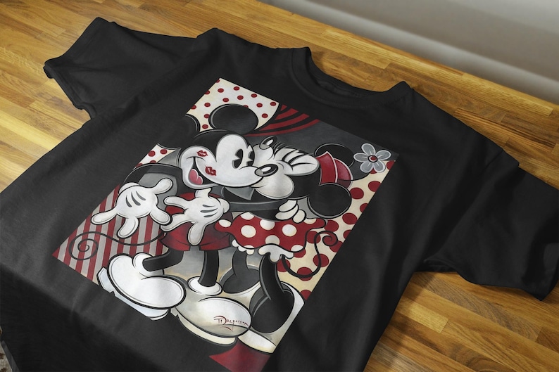 May include: Black t-shirt with a graphic print of Mickey Mouse and Minnie Mouse kissing. The graphic is in a red, white, and black color scheme with polka dots and stripes.