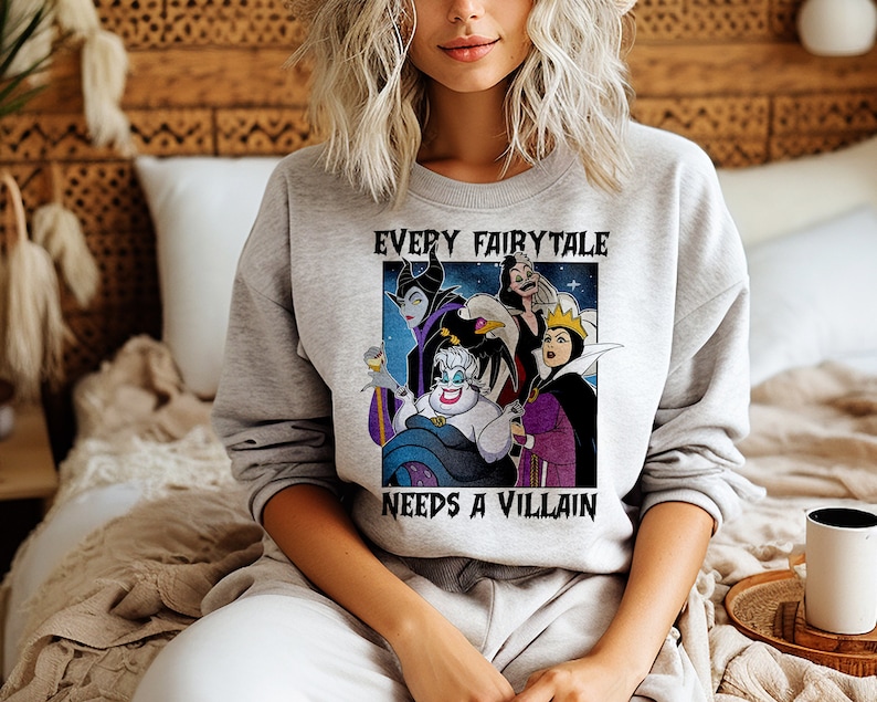 Puede incluir: Una sudadera gris con un gr&aacute;fico de villanos de Disney, incluyendo a &Uacute;rsula, Mal&eacute;fica y la Reina Malvada. El texto "EVERY FAIRYTALE NEEDS A VILLAIN" est&aacute; impreso encima y debajo del gr&aacute;fico. La sudadera es de material suave.