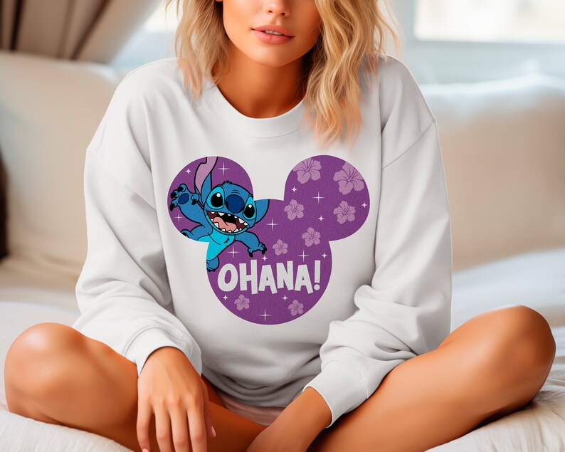 May include: White sweatshirt with a purple Mickey Mouse ear design featuring Stitch from Lilo & Stitch. The design includes pink flowers and the text "Ohana!"