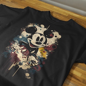May include: Black t-shirt with a colorful graphic of Mickey Mouse in a vintage style.