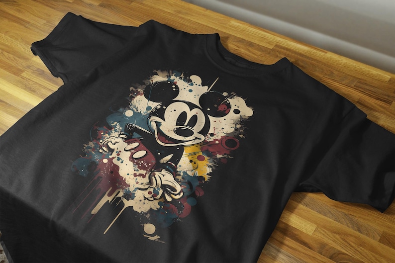May include: Black t-shirt with a colorful graphic of Mickey Mouse in a vintage style.