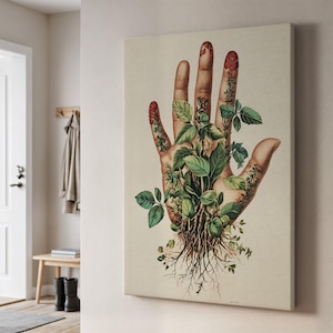 May include: A canvas print depicting a human hand with botanical details. The hand is decorated with green leaves and roots, with red accents on the fingertips. The artwork is displayed on a neutral-toned wall, suitable for home decor.