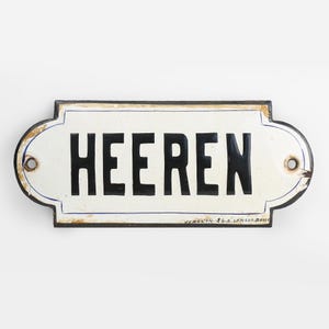 May include: A white enamel sign with black lettering that reads "HEEREN". The sign has a rounded rectangular shape with a black border and blue trim.
