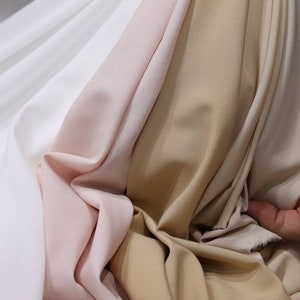 Samples of the fabrics from which the dresses are made.