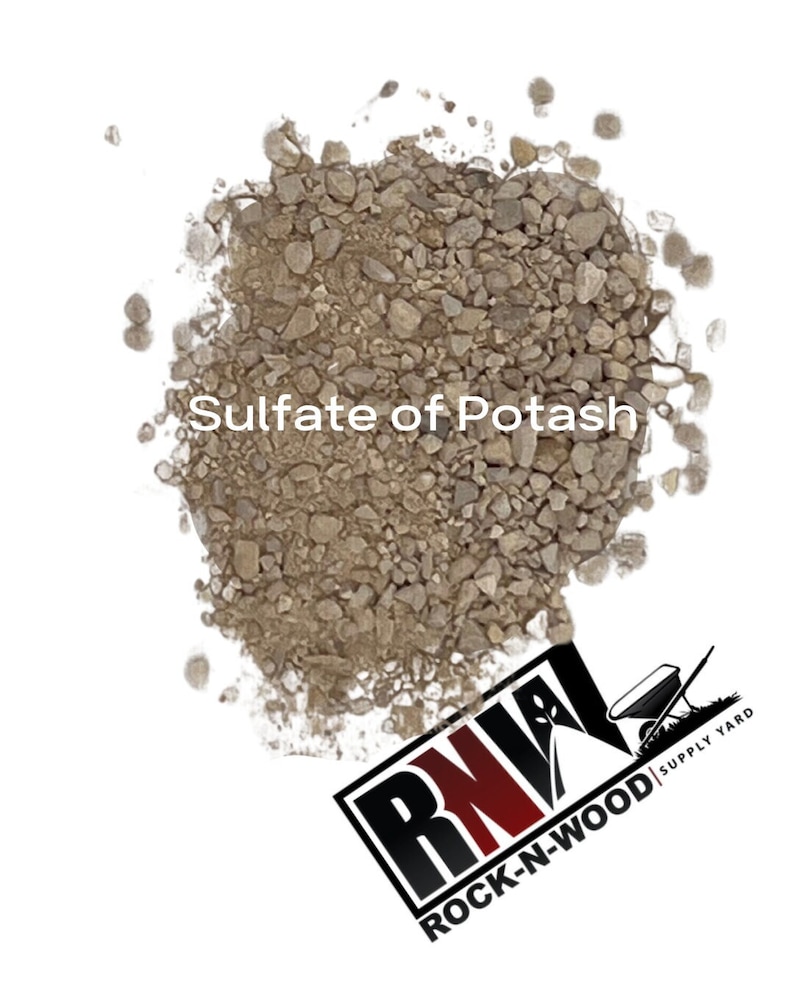 May include: A close-up of a pile of brown sulfate of potash fertilizer. The fertilizer is a granular material and is commonly used to improve soil health.