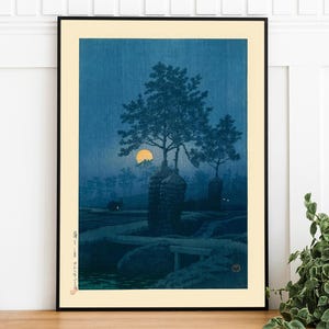 May include: A Japanese woodblock print depicting a moonlit night scene with a large tree and two smaller trees in the background. The moon is a bright yellow circle in the sky. The print is in shades of blue and yellow.