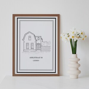 May include: A black and white line drawing of a house with a wooden frame. The drawing is framed and includes the text "ADELSTRAAT 50 - LEIDEN -" at the bottom.