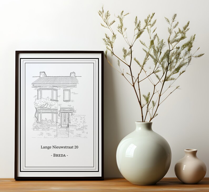 May include: A black framed print of a line drawing of a house with the address "Lange Nieuwstraat 20 - Breda" printed below the image. The print is displayed on a wall next to a light green ceramic vase with a branch of dried greenery and a smaller beige ceramic vase.
