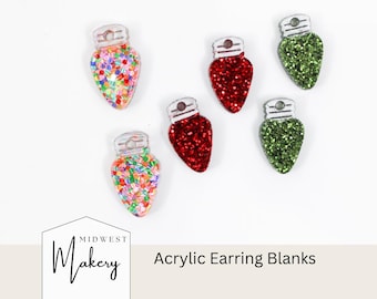 May include: Acrylic earring blanks in the shape of Christmas lights. The blanks are in red, green, and multicolored glitter. The earring blanks have a silver-colored top. The text "Acrylic Earring Blanks" is visible.