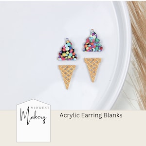 Può includere: Due paia di basi per orecchini in acrilico a forma di coni gelato. La parte del gelato è un motivo a coriandoli colorati e il cono è un motivo a cialda marrone chiaro. Il testo "Midwest Makery Acrylic Earring Blanks" è nella parte inferiore dell'immagine.