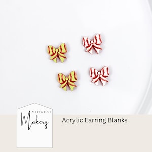 May include: Four acrylic earring blanks shaped like softball bows. Two bows are yellow with red stitching, and two are red with white stitching. The text "Midwest Makery" and "Acrylic Earring Blanks" are also visible.