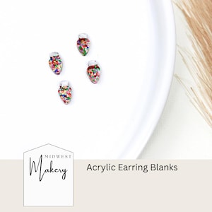 May include: Four colorful acrylic earring blanks shaped like Christmas lights. The blanks are on a white surface with the text "Midwest Makery Acrylic Earring Blanks".