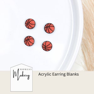 May include: Four orange and black basketball-themed acrylic earring blanks on a white surface. The text "Midwest Makery" and "Acrylic Earring Blanks" is visible in the image.