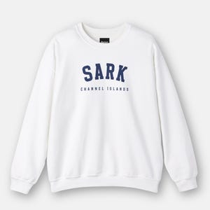May include: White crewneck sweatshirt with a navy blue embroidered logo that says "SARK CHANNEL ISLANDS".