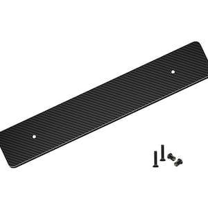 May include: A rectangular black carbon fiber panel with a textured weave pattern. The panel has rounded corners and two pre-drilled holes. Several small black screws are positioned near the panel, suggesting installation hardware.