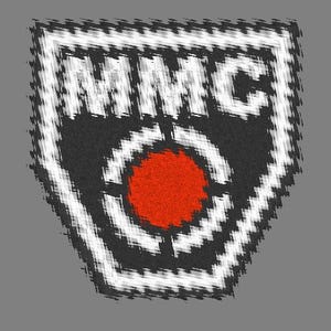 May include: A graphic design featuring the letters "MMC" in white, set against a black and gray background with a red center. The design has a target-like appearance with a geometric pattern.