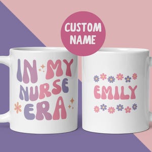 May include: Two white ceramic mugs with colorful text and designs. One mug says "IN MY NURSE ERA" in pink, purple, and orange. The other mug says "EMILY" in pink with floral accents. A pink circle above says "CUSTOM NAME".