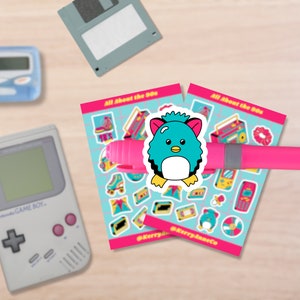 May include: Two sheets of stickers with a 90s theme. The stickers feature images of a boombox, roller skates, a cassette tape, a Tamagotchi, a Game Boy, a scrunchie, a baby bottle, a floppy disk, a CD, and a fuzzy blue penguin. The text on the stickers reads "All About the 90s" and "@KerryJaneCo".