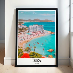 May include: A framed poster featuring a photograph of a white building on a beach with turquoise water. The text "IBIZA SPAIN" is at the bottom of the poster.