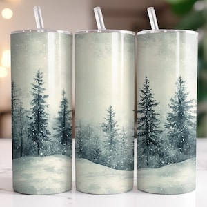 May include: Three stainless steel tumblers with a winter forest scene. The tumblers feature a snowy landscape with pine trees and a light blue sky.