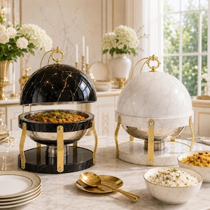 May include: Two round buffet chafing dishes with dome lids, one in black marble finish and one in white marble finish. Both feature gold-tone metal stands, handles, and trim. Each unit includes a stainless steel food pan and a base.