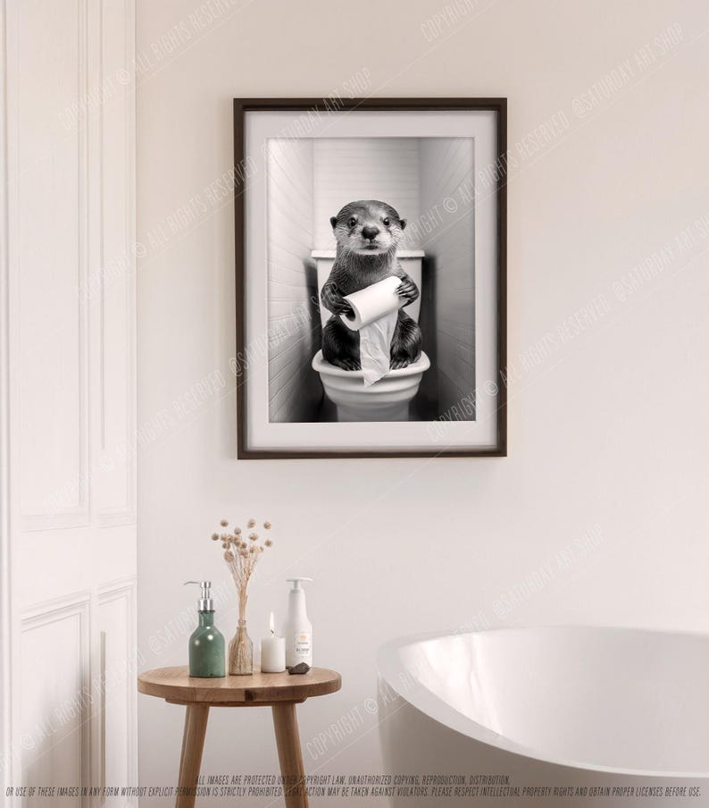 May include: A black and white photo of an otter sitting on a toilet holding a roll of toilet paper. The otter is looking directly at the camera.