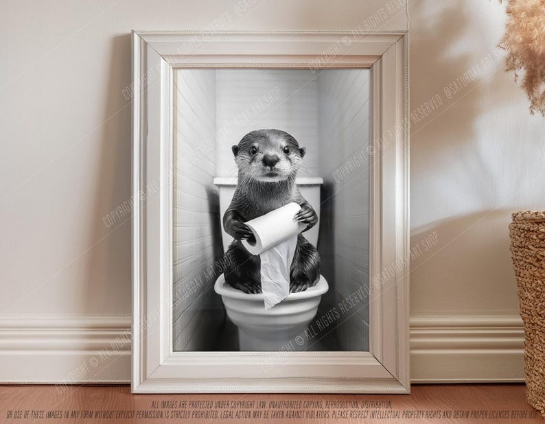 May include: A black and white photo of an otter sitting on a toilet holding a roll of toilet paper. The otter is looking at the camera.