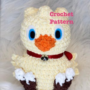 May include: A cream-colored crochet chick plush toy with bright blue eyes, an orange beak, and a red collar featuring a small silver bell. The chick has brown feet with white tips. The text Crochet Pattern is printed in pink on the upper right.
