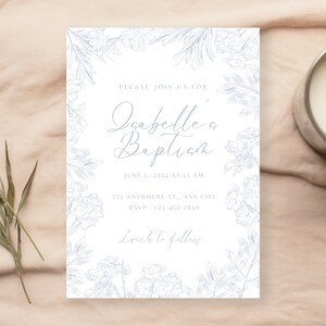 May include: A white card with a blue floral border and the text "Please join us for Isabelle's Baptism" with the date and time of the event, the address, and RSVP information. The text "Lunch to follow" is at the bottom of the card.
